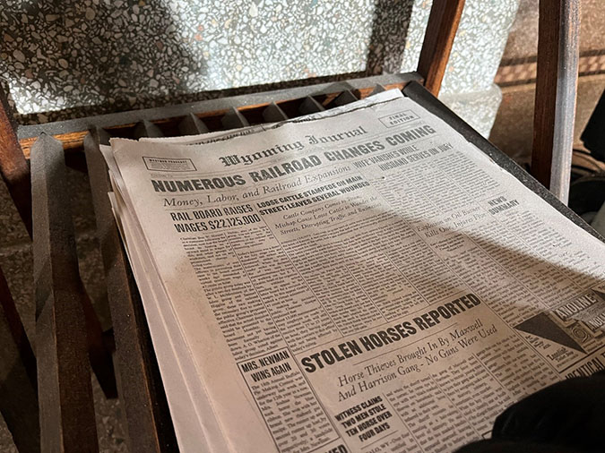 Prop newspapers with news of the times are seen around the interior of the Butte depot.