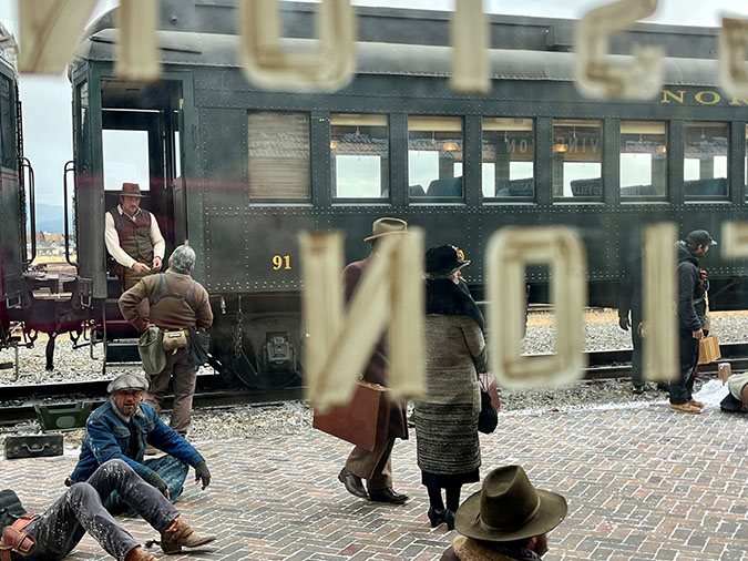 Brandon Sklenar, who plays Spencer Dutton, stands on the train in between takes  