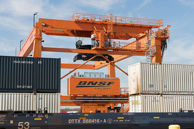 Intermodal crane moving intermodal cars at Alliance Yard in Fort Worth, Texas
