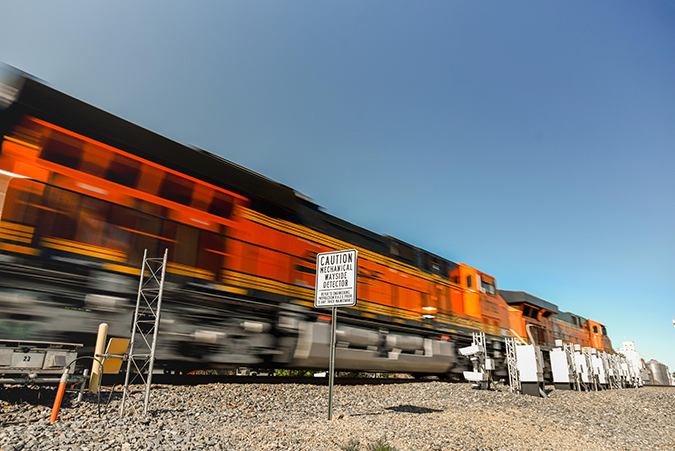 A BNSF train passes by wayside detectors. A BNSF train passes by wayside detectors.