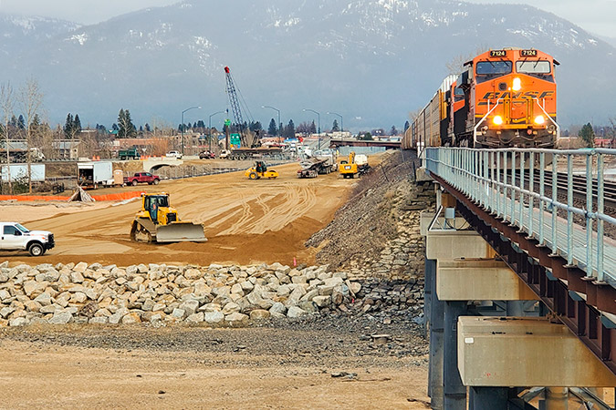 A BNSF train approaches the north end of the existing bridge at Sandpoint, with construction of the new bridge adjacent. Photo by Jeremy Kruskie, BNSF A BNSF train approaches the north end of the existing bridge at Sandpoint, with construction of the new bridge adjacent. Photo by Jeremy Kruskie, BNSF