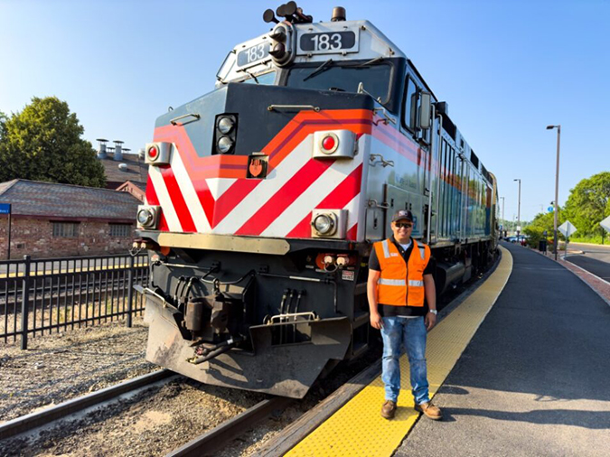 Molina in front of a Metra commuter train at the Aurora, Illinois, passenger station Molina in front of a Metra commuter train at the Aurora, Illinois, passenger station