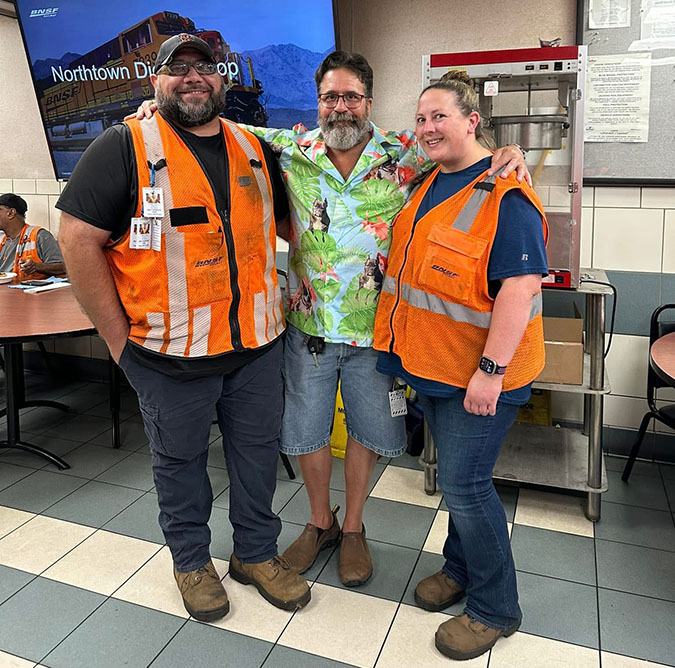 Kimberly and Matt Dunn (in orange vest) with a coworker. Kimberly and Matt Dunn (in orange vest) with a coworker.