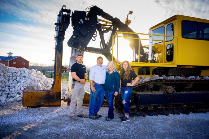Pictured from left: Elizabeth’s brother, Adam; father, Wayne; mother, Lori; and Elizabeth standing with their plow used for installing soil drainage Pictured from left: Elizabeth’s brother, Adam; father, Wayne; mother, Lori; and Elizabeth standing with their plow used for installing soil drainage