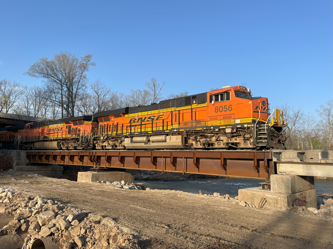 The first train crosses a newly built rail bridge in Mammoth Spring, Arkansas, just five days after the previous bridge was washed away by flooding. The first train crosses a newly built rail bridge in Mammoth Spring, Arkansas, just five days after the previous bridge was washed away by flooding.
