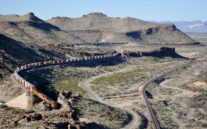 From Julien’s collection, a BNSF train parallels a portion of Route 66 near Kingman, Arizona. From Julien’s collection, a BNSF train parallels a portion of Route 66 near Kingman, Arizona.