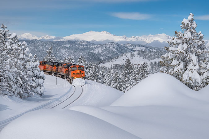 BNSF train passing through a snowy landscape in Colorado. Photo by Erik Lindgren. BNSF train passing through a snowy landscape in Colorado. Photo by Erik Lindgren.