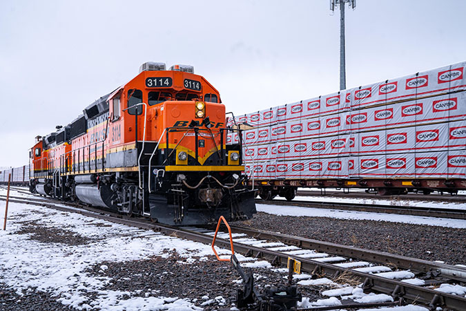 A remote-controlled locomotive parked next to centerbeam flatcars carries lumber at the Amarillo South Yard in Amarillo, Texas. A remote-controlled locomotive parked next to centerbeam flatcars carries lumber at the Amarillo South Yard in Amarillo, Texas.