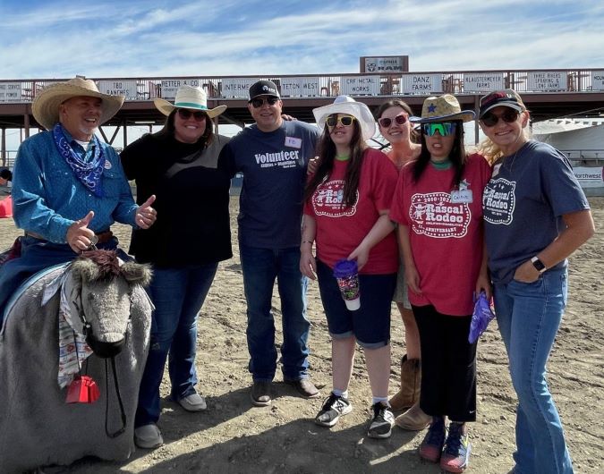 McCord, center, with family members and rodeo volunteers at an event McCord, center, with family members and rodeo volunteers at an event