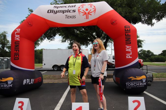 BNSF’s Katie Hower presenting a medal to a Special Olympics athlete. BNSF’s Katie Hower presenting a medal to a Special Olympics athlete.