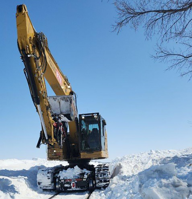 Excavators are among the arsenal for digging out the railroad. Excavators are among the arsenal for digging out the railroad.