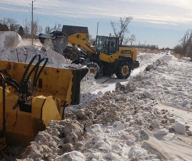 Warmer days require moving the snow, sometimes amid mud buildup. Warmer days require moving the snow, sometimes amid mud buildup.
