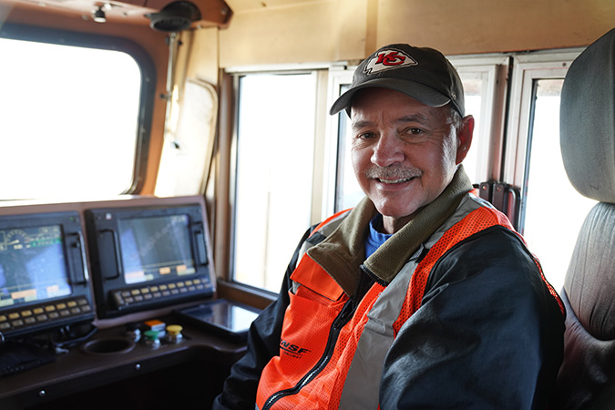 Brett in the engineer’s seat of a locomotive. Brett in the engineer’s seat of a locomotive.