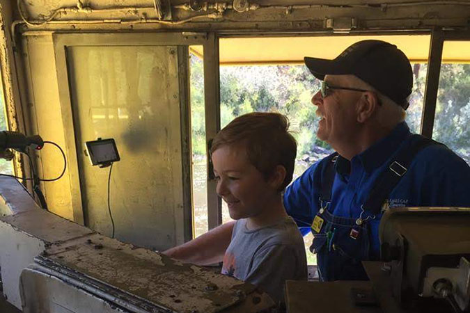 Alexander (at age 5) and an engineer from the Eagle Cap Excursion Train in the cab of a locomotive Alexander (at age 5) and an engineer from the Eagle Cap Excursion Train in the cab of a locomotive
